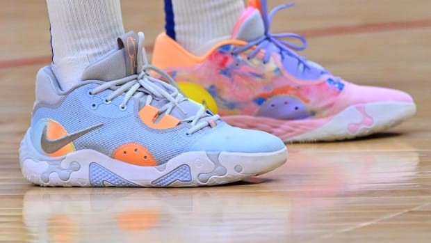 View of blue and pink Nike shoes.